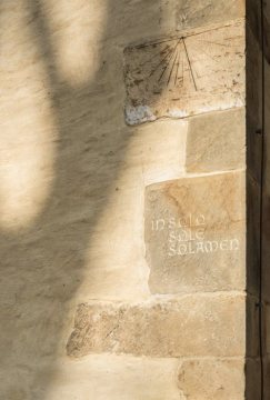Ev. Pfarrkirche Enger, Sonnenuhr an der Südfassade. Inschrift: "In Solo Sole Solamen" [In der Sonne allein ist Trost].