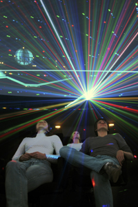 Besucher schauen sich eine Lasershow im Planetarium an