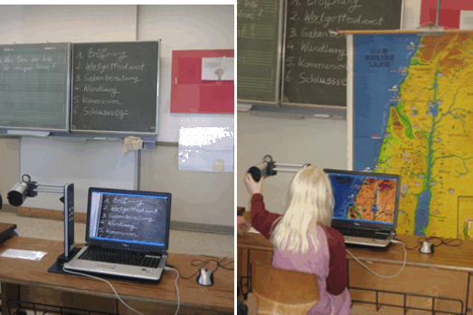 Schülerin betrachtet Tafelanschrieb bzw. Landkarte mittels Kamera am Monitor