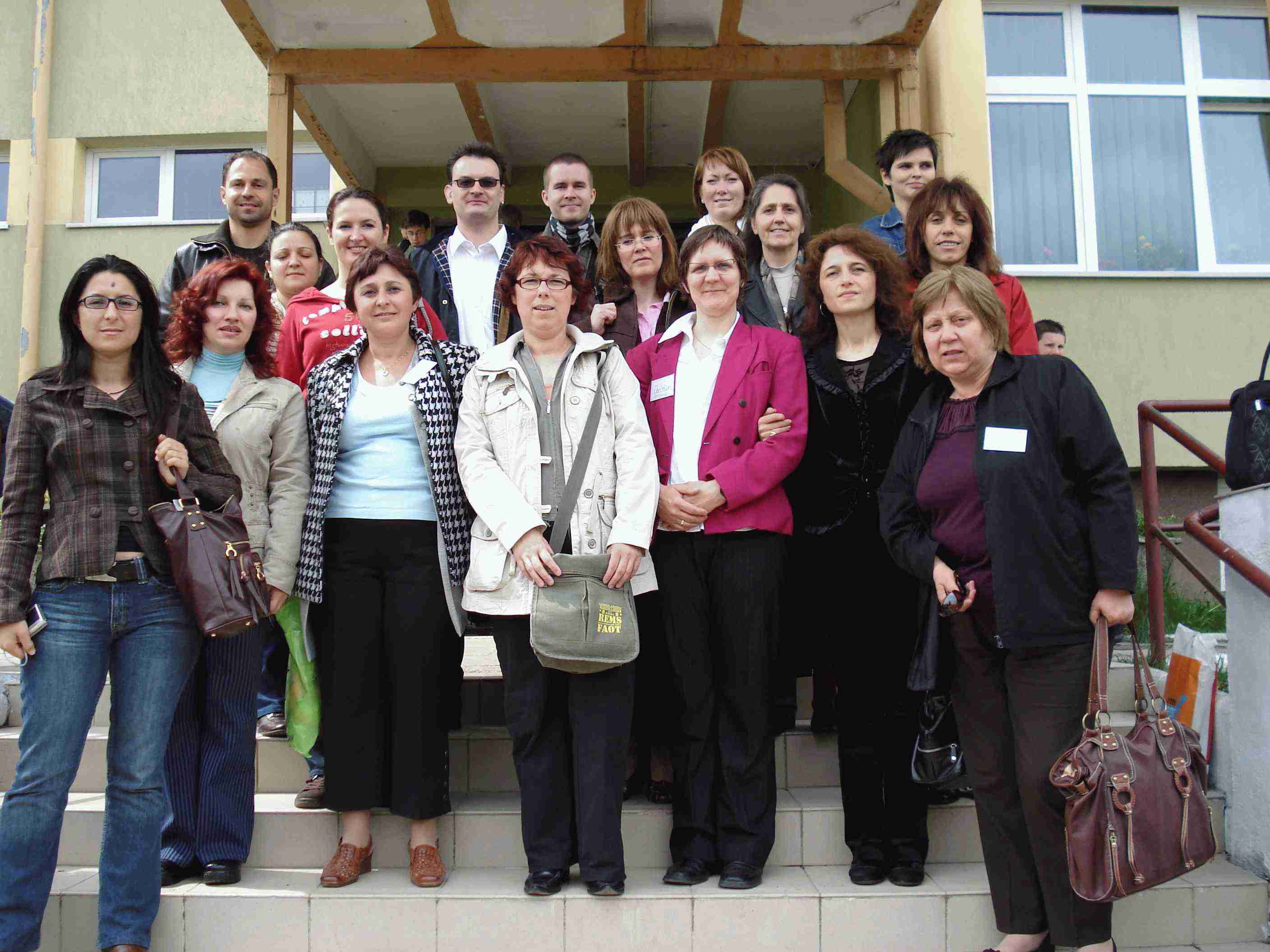 You can see the group of all teachers in front of the school