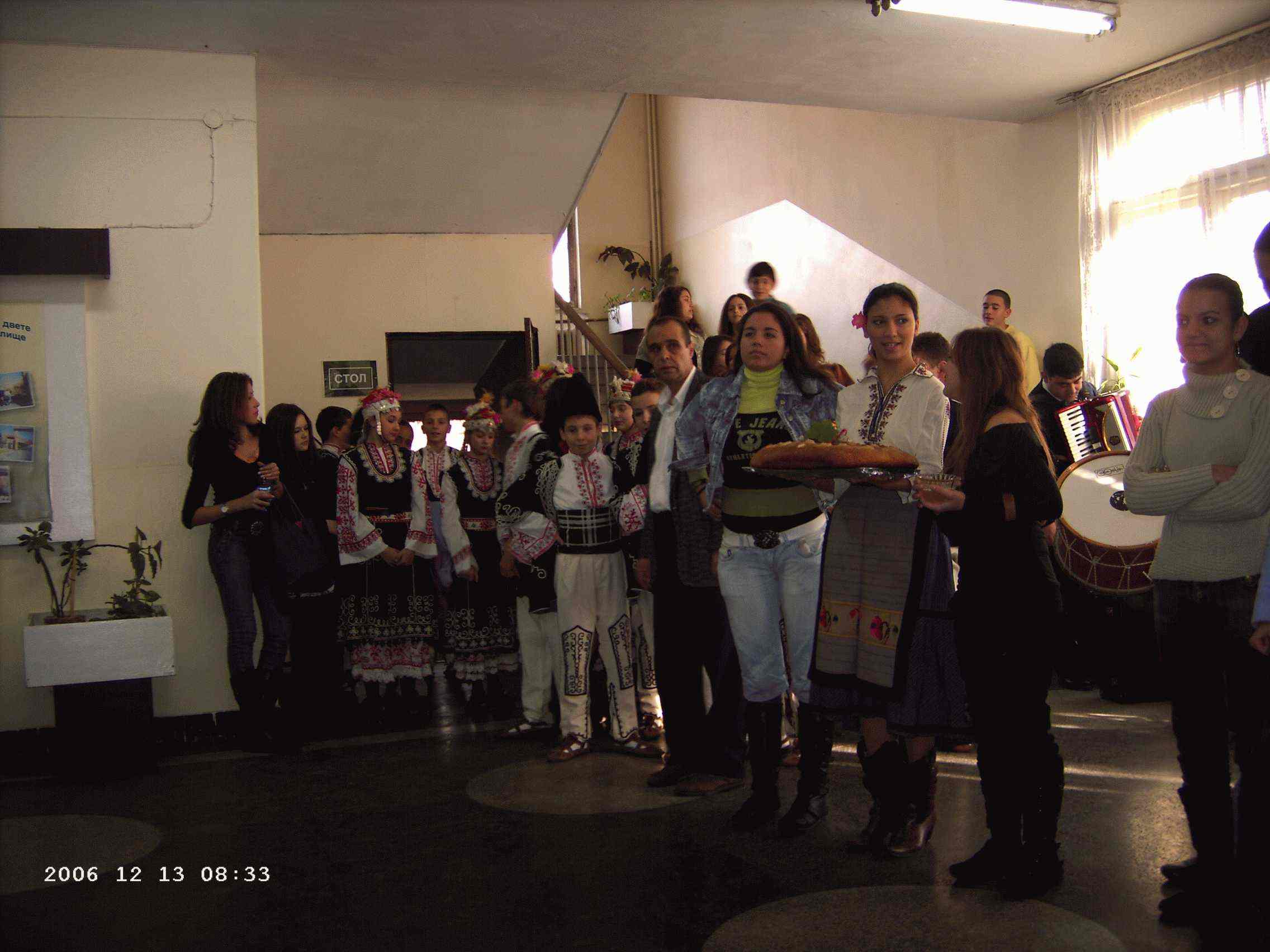  You can see a group of pupils in traditional Bulgarian clothes holding a Bulgarian bread and honey for the Comenius guests.