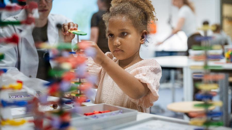 Ein Kind experimentiert im Gene-Lab in der aktuellen Ausstellung "Gene - Vielfalt des Lebens".