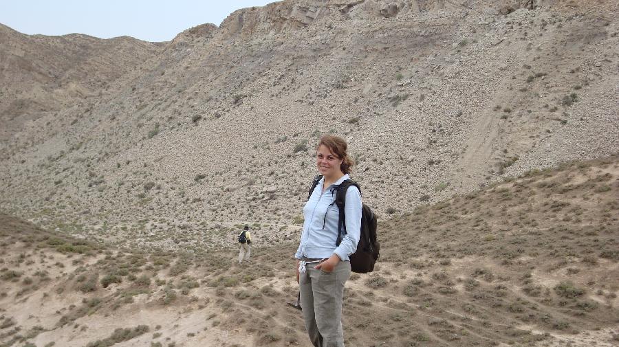 EIne Frau steht in Outdoorkleidung vor einem Berg in China