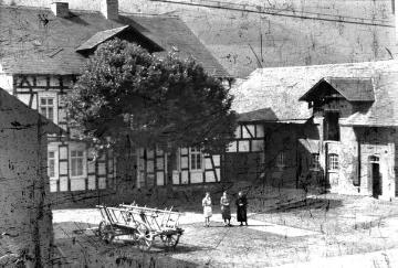 Hof Dümpelmann, erbaut 1878 östlich der Dorflage an der Provinzialstraße, Bildmitte: Maria Dümpelmann (rechts) und Tochter Elfriede (links) mit Adele Fastenrath, Gattin des Fotografen