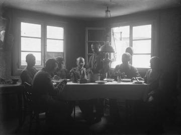 Erster Weltkrieg, Elsass [?]: Richard Schirrmann (vor dem rechten Fenster) in einer Männerrunde bei der Mahlzeit im Gasthof, ohne Ort, undatiert