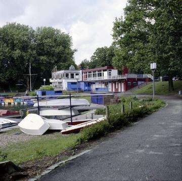 Aasee Höhe Annette-Allee: Bootsverleih und Segelschule Overschmitt mit Café-Restaurant Aasee-Terrassen, Abriss 2006, Neubebauung des Ufers ab 2007