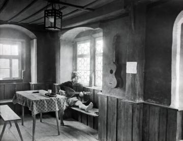 Jugendherberge Ochsenfurt a.M., junger Mandolinenspieler im Tagesraum, undatiert, um 1920?