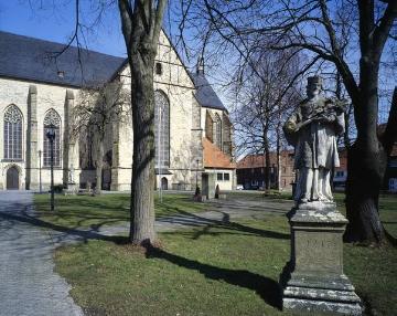 St. Cosmas und Damian-Kirche, ehemalige Klosterkirche des 1803 aufgelösten Benediktinerklosters Abtei Liesborn - im Vordergrund: Standbild des Hl. Johannes Nepomuk von 1747