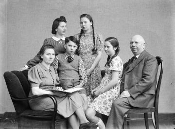 Familie Jäger um 1940: Fotograf Ernst Jäger und Ehefrau Agnes mit ihren Kindern Hermann und Irene (sitzend), Margret und Agnes. Atelier Jäger, Harsewinkel, undatiert.