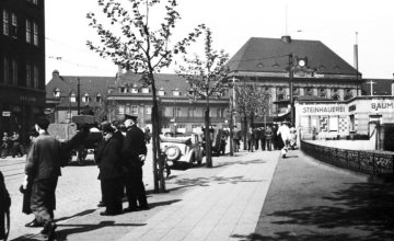 Bahnhof Hamm um 1935: Vorplatz mit Empfangsgebäude von 1920. Rechts: Pavillon einer Steinhauerei. Undatiert.