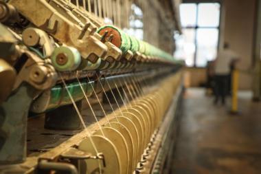 Die zwölf Meter lange Ringspinnmaschine läuft am 15. Februar in der Spinnerei.<br>Foto: LWL/Betz
