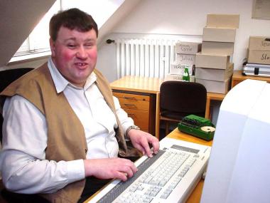 Dietmar Schade hat an seinem Computer mit Blindenschrift-Ausgabe die LWL-Kunstausstellung konzipiert.<br>Foto: LWL/Tiemann</br>