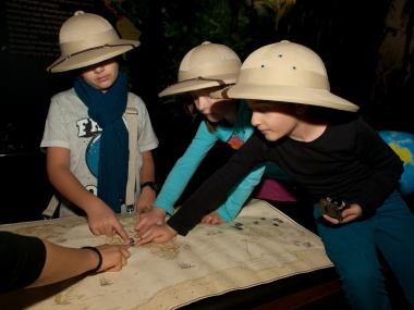 Mit Tropenhelm, Lupe und Landkarte sind die Schulkinder unterwegs im LWL-Museum für Archäologie in Herne und erkunden die Sonderausstellung ¿Schädelkult¿.<br> Foto: LWL/Brentführer<br />