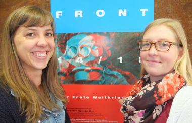 Sonja Meßling (l.) und Astrid Gonstalla vor dem Plakat der aktuellen Ausstellung ¿Front 14/18¿. <br>Foto: LWL 