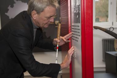 Gerd Kozyk ertastet die Brailleschrift auf einem Exponat in der neuen Dauerausstellung.<br>Foto: LWL/Hudemann