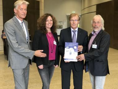 NRW-Justizminister Peter Biesenbach (3.v.l.) erhält von den Vertretern der Überörtlichen Arbeitsgemeinschaft für das Betreuungswesen in Nordrhein-Westfalen (ÜAG) Georg Dodegge, Karin Wallbaum und Lothar Buddinger (v.l.) die neuen Broschüren zum Thema "Freiheitsentziehende Maßnahmen in der Pflege" überreicht.<br>Foto: NRW-Ministerium der Justiz/Dirk Reuter