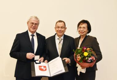 Klaus Baumann, Vorsitzender der LWL-Landschaftsversammlung (links), überreicht Dr. Heinz Börger die Freiherr-vom-Stein-Medaille in Silber. An seiner Seite Börgers Ehefrau Mechthild.<br>Foto: LWL