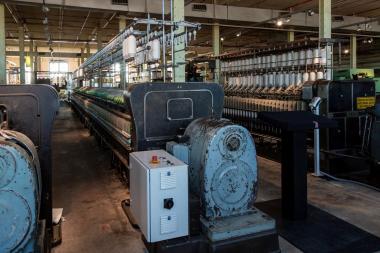 Die restaurierte Spinnmaschine steht genau an der Stelle im alten Spinnsaal, wo bis 1973 ähnliche Ringspinnmaschinen Garn produziert haben.<br>Foto: Holtappels/LWL